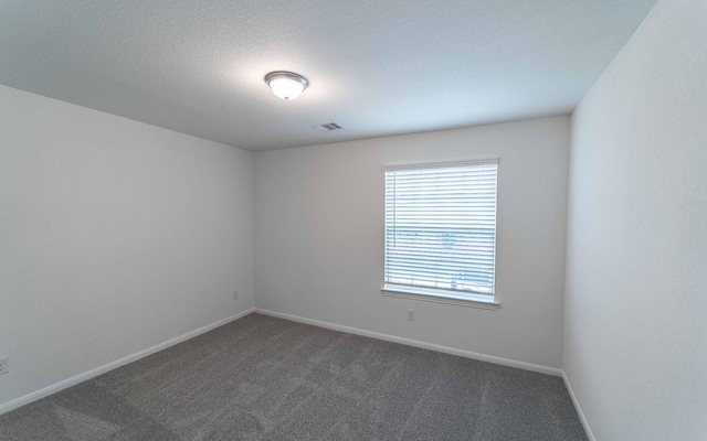 3109 Aqua Wave Dr, Texas City, TX 77568 - empty room featuring dark colored carpet, baseboards, and a textured ceiling