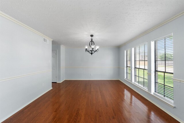 unfurnished dining area featuring a chandelier, wood finished floors, visible vents, and ornamental molding