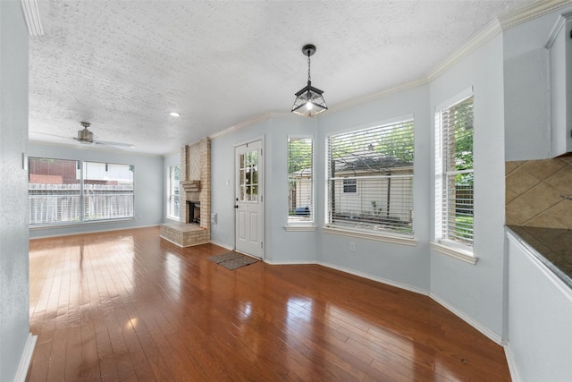 interior space featuring a fireplace, a textured ceiling, and a healthy amount of sunlight