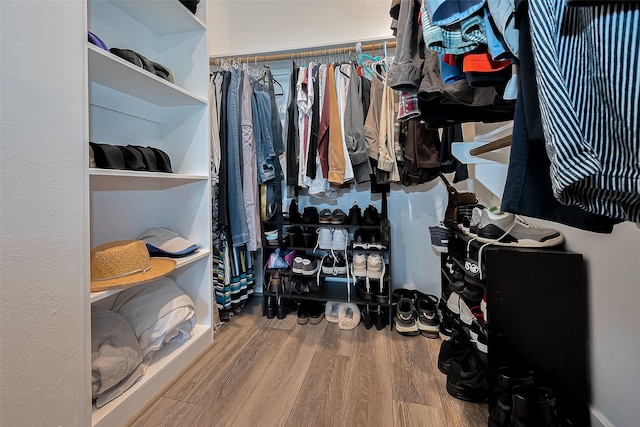 spacious closet featuring wood finished floors