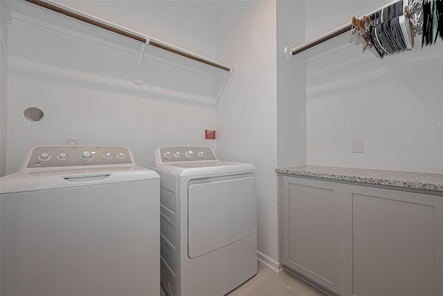 clothes washing area with washing machine and dryer