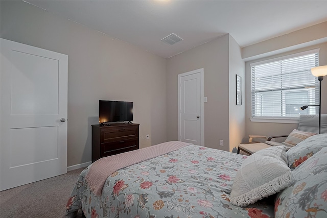 carpeted bedroom featuring visible vents and baseboards