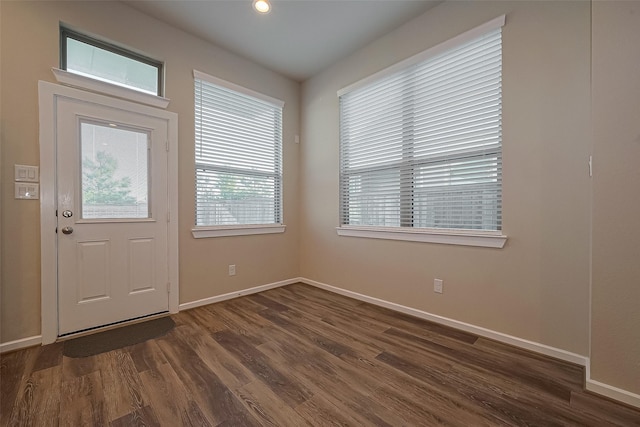 entryway featuring dark wood-type flooring and baseboards