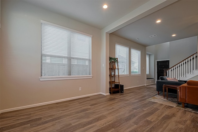 interior space featuring baseboards, recessed lighting, stairs, visible vents, and wood finished floors