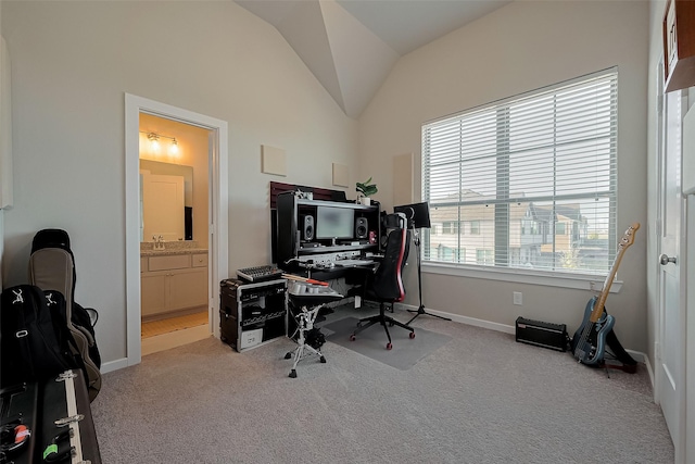 office with light carpet, baseboards, and lofted ceiling