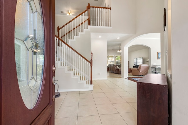 12506 Opal Valley Dr, Tomball, TX 77377 - foyer featuring light tile patterned flooring, a high ceiling, ceiling fan, and stairs