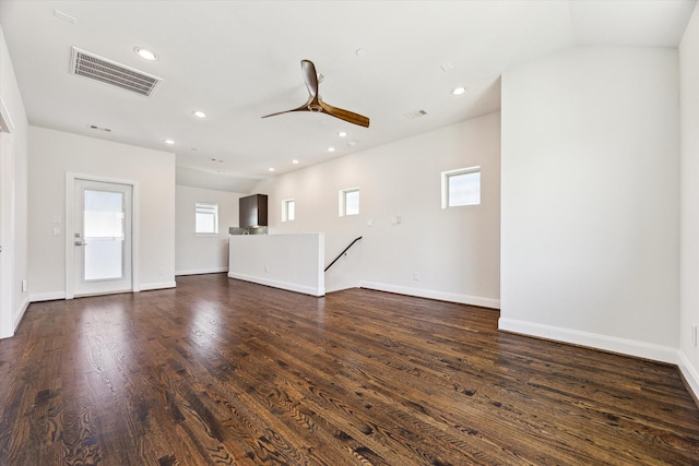 unfurnished living room featuring a ceiling fan, visible vents, dark wood-type flooring, and a healthy amount of sunlight
