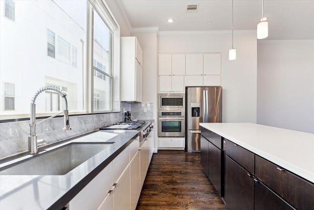 kitchen with stainless steel appliances, a sink, dark brown cabinets, visible vents, and white cabinetry