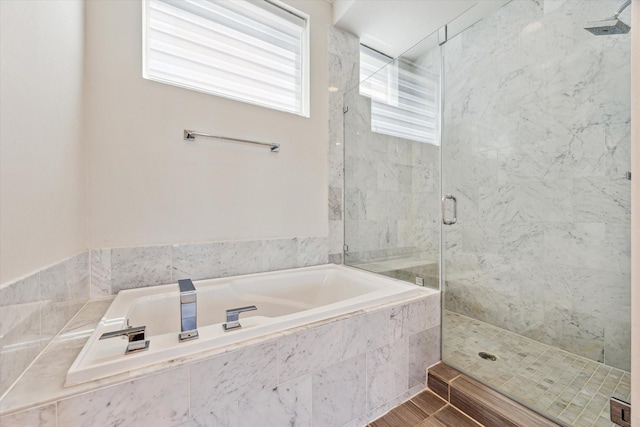 full bath with a garden tub and a stall shower