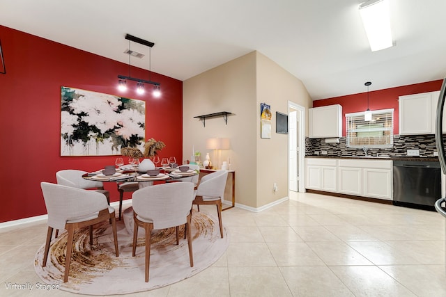 dining room with visible vents, baseboards, vaulted ceiling, and light tile patterned floors