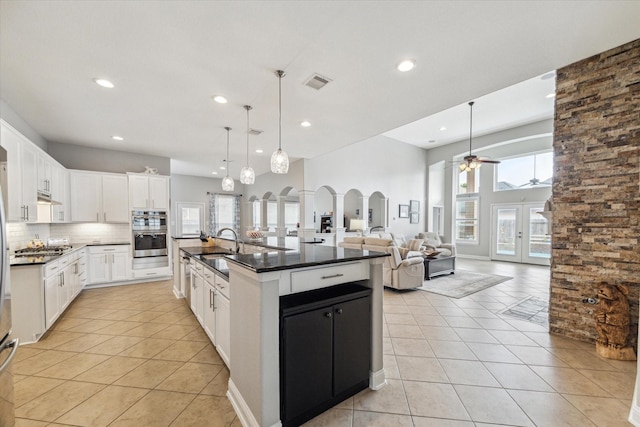 kitchen featuring recessed lighting, dark countertops, visible vents, and light tile patterned floors