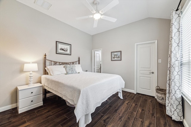 bedroom with visible vents, baseboards, dark wood-type flooring, and lofted ceiling