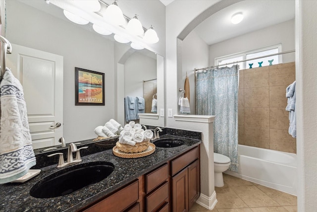 bathroom with a sink, tile patterned flooring, shower / bath combo, and toilet
