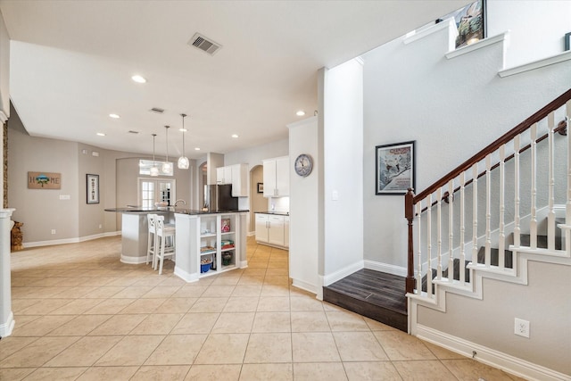 entryway featuring recessed lighting, visible vents, light tile patterned floors, and stairway