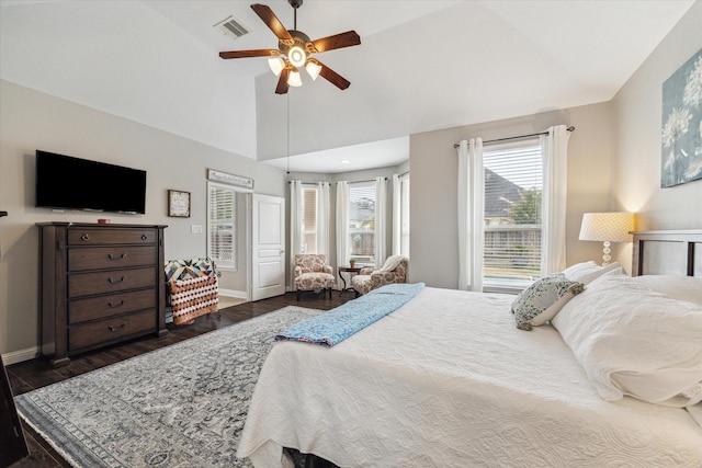 bedroom with vaulted ceiling, multiple windows, dark wood-type flooring, and visible vents