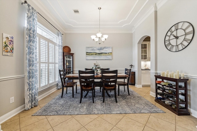 4707 Middlewood Manor Ln, Katy, TX 77494 - dining space with arched walkways, a chandelier, light tile patterned flooring, a tray ceiling, and ornamental molding