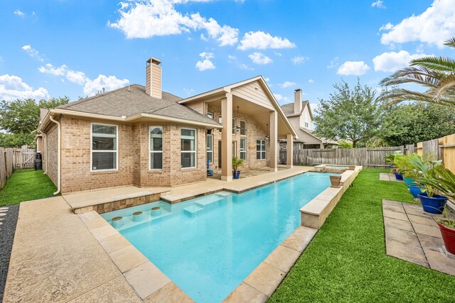 view of pool with a lawn, a fenced backyard, and a patio area