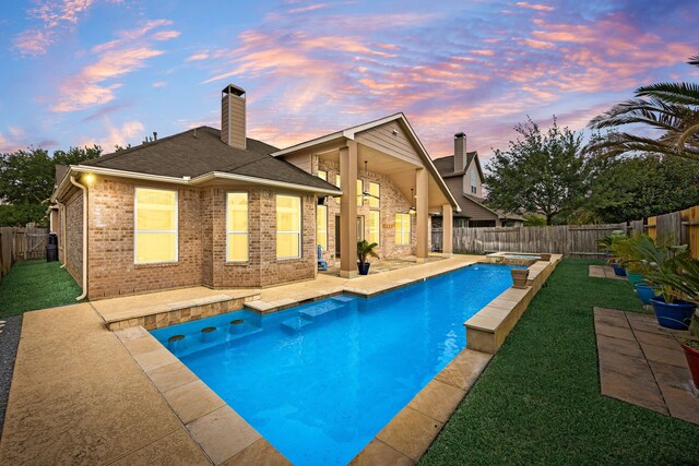 view of swimming pool with a patio, a fenced backyard, and a yard