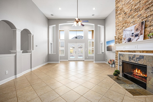 living area with light tile patterned flooring, a fireplace, a high ceiling, recessed lighting, and a ceiling fan