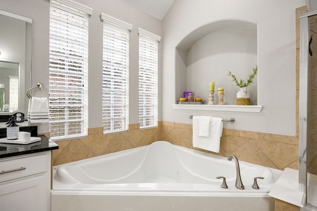 full bathroom featuring vanity and a bath