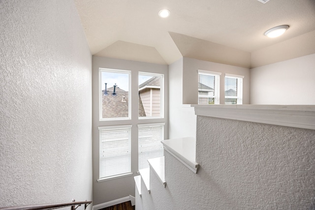 stairs featuring a textured wall and a wealth of natural light