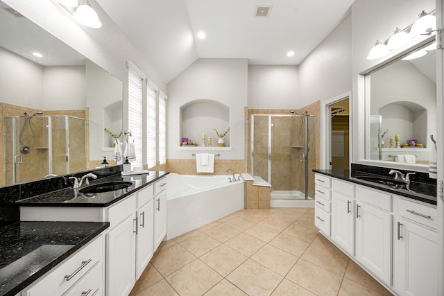 bathroom featuring a sink, a stall shower, a bath, and visible vents