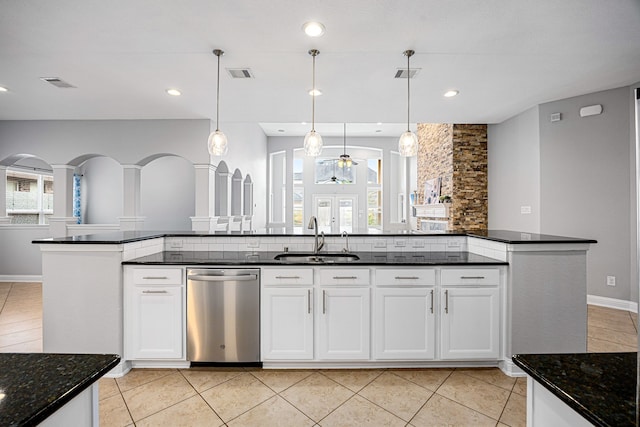 kitchen with stainless steel dishwasher, a sink, and visible vents