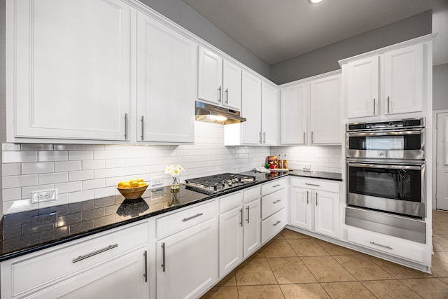 kitchen featuring under cabinet range hood, appliances with stainless steel finishes, a warming drawer, and white cabinets