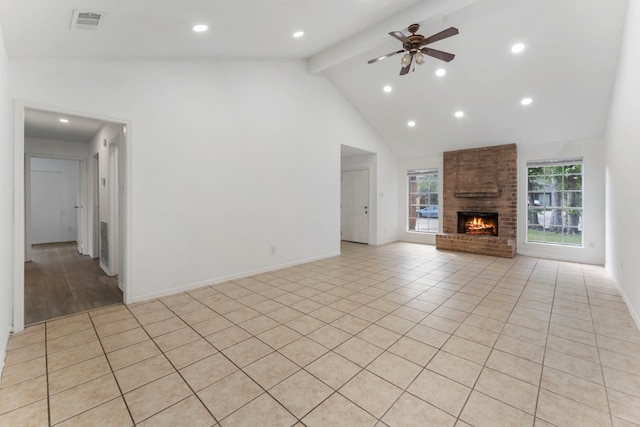 19822 Brightstone Dr, Humble, TX 77338 - unfurnished living room with visible vents, a ceiling fan, a fireplace, beamed ceiling, and high vaulted ceiling