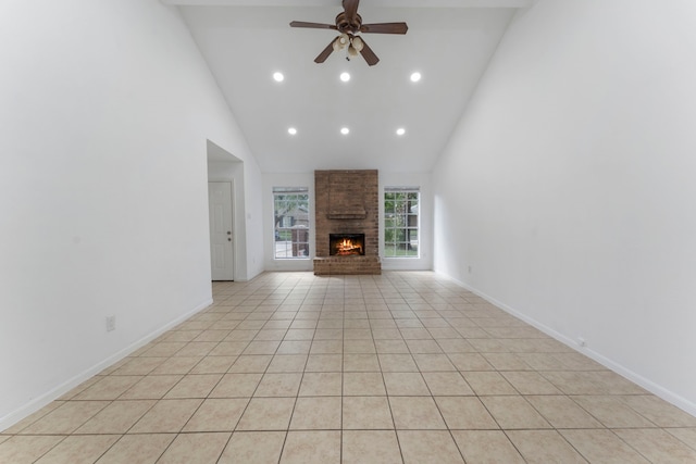 19822 Brightstone Dr, Humble, TX 77338 - unfurnished living room featuring high vaulted ceiling, a brick fireplace, baseboards, and a ceiling fan
