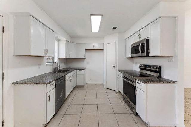 19822 Brightstone Dr, Humble, TX 77338 - kitchen featuring light tile patterned floors, white cabinets, visible vents, appliances with stainless steel finishes, and a sink