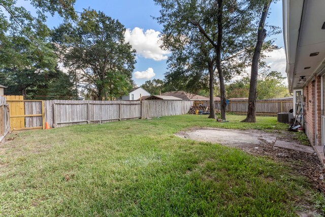 19822 Brightstone Dr, Humble, TX 77338 - view of yard with central AC, a fenced backyard, and a patio