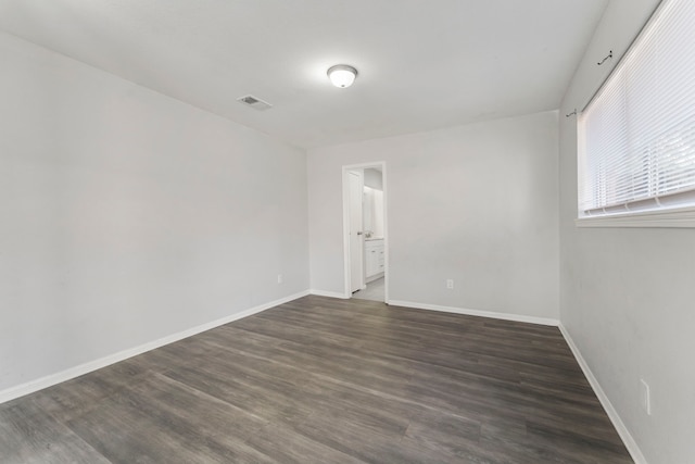 19822 Brightstone Dr, Humble, TX 77338 - empty room featuring baseboards, dark wood-style floors, and visible vents