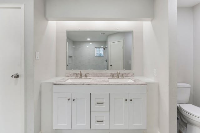 19822 Brightstone Dr, Humble, TX 77338 - bathroom featuring toilet, double vanity, a sink, and walk in shower