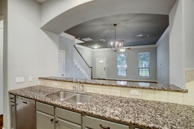 kitchen with crown molding, light stone countertops, a sink, decorative light fixtures, and stainless steel dishwasher