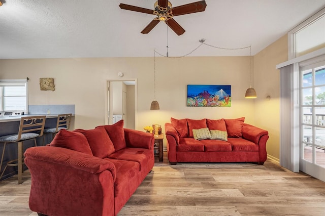 living room with wood finished floors and ceiling fan