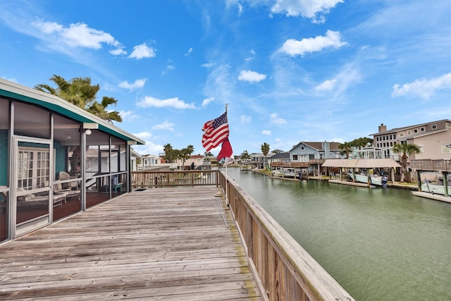 view of dock featuring a residential view and a deck with water view
