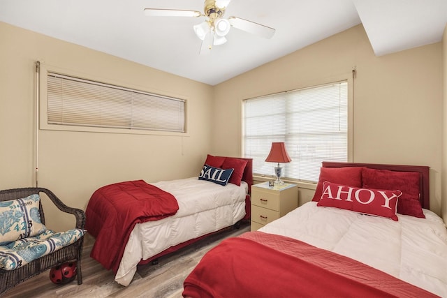 bedroom with lofted ceiling, ceiling fan, and wood finished floors