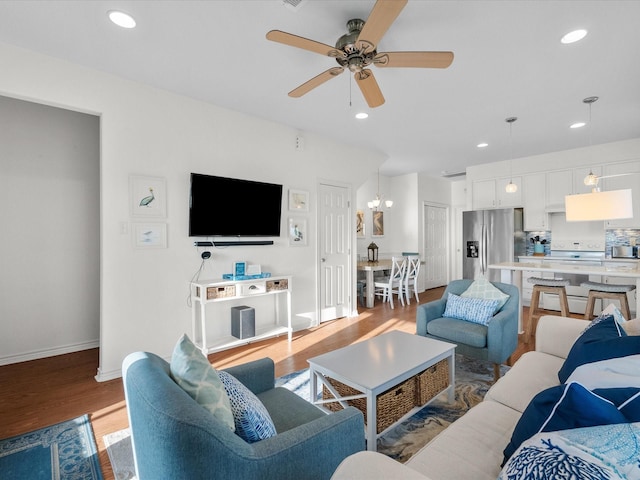 living area with baseboards, recessed lighting, ceiling fan, and wood finished floors
