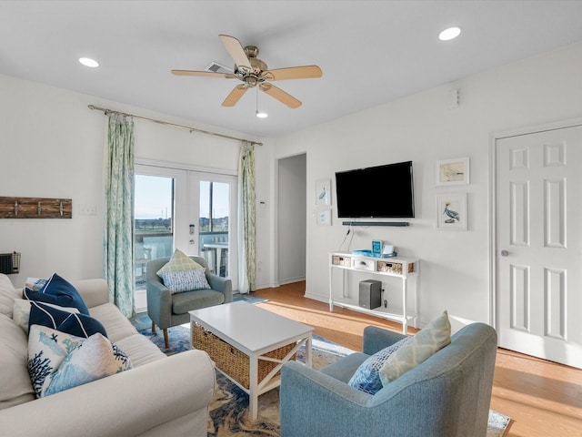 living room featuring a ceiling fan, recessed lighting, french doors, and light wood-type flooring