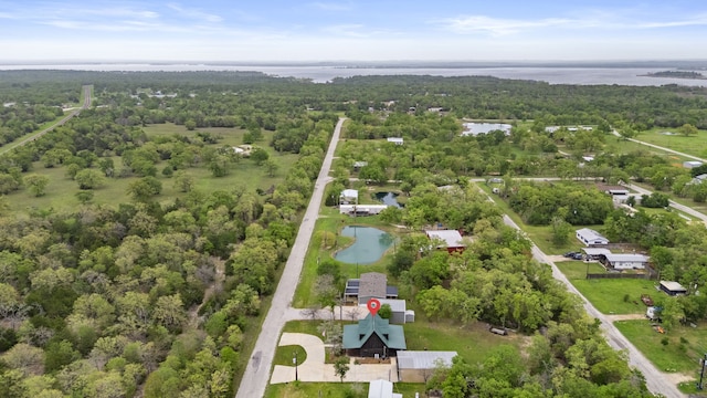 birds eye view of property with a water view and a view of trees