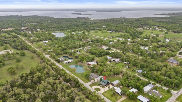 aerial view featuring a water view and a wooded view