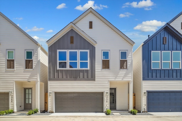 view of front of home with an attached garage, board and batten siding, and driveway