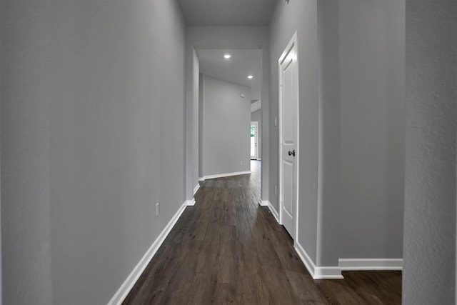 hallway with baseboards, dark wood-type flooring, and recessed lighting