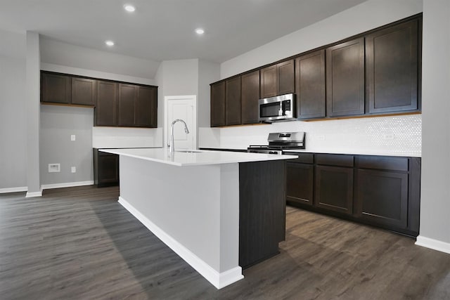 kitchen with dark wood-type flooring, dark brown cabinetry, stainless steel appliances, and a sink