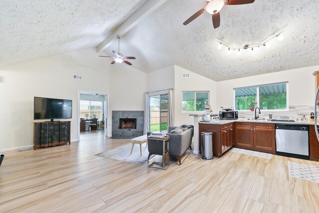 kitchen with stainless steel appliances, open floor plan, visible vents, and ceiling fan