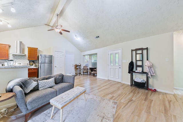 living room featuring a textured ceiling, light wood-style floors, visible vents, beam ceiling, and ceiling fan