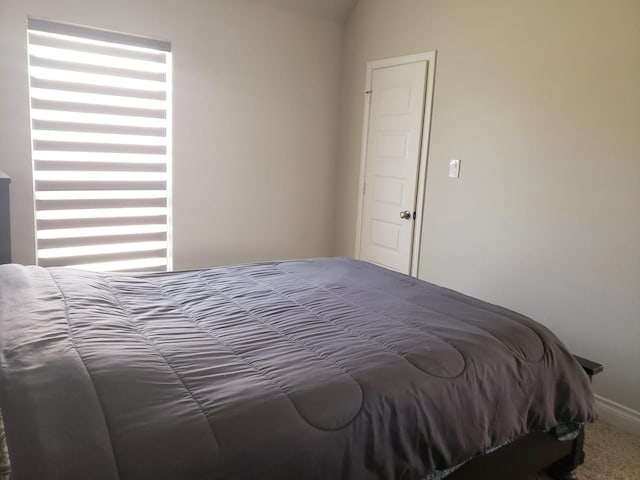 carpeted bedroom with baseboards