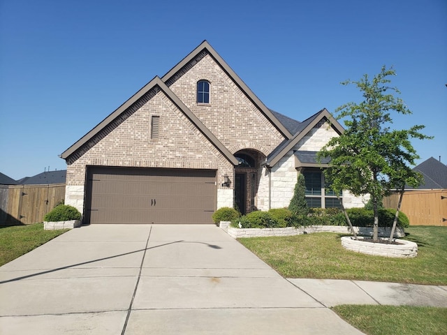 2227 Marian Lee, Richmond, TX 77469 - french provincial home with driveway, a front yard, brick siding, fence, and stone siding