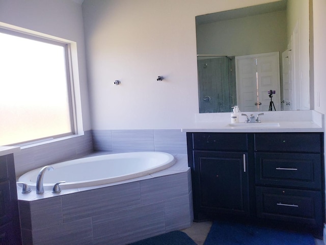bathroom featuring vanity, a bath, and a stall shower